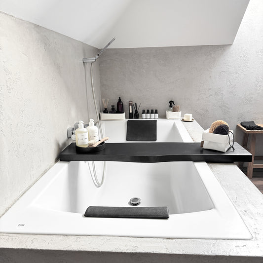 Black live-edge bath caddy, front-view spa tray cradling tub-side essentials