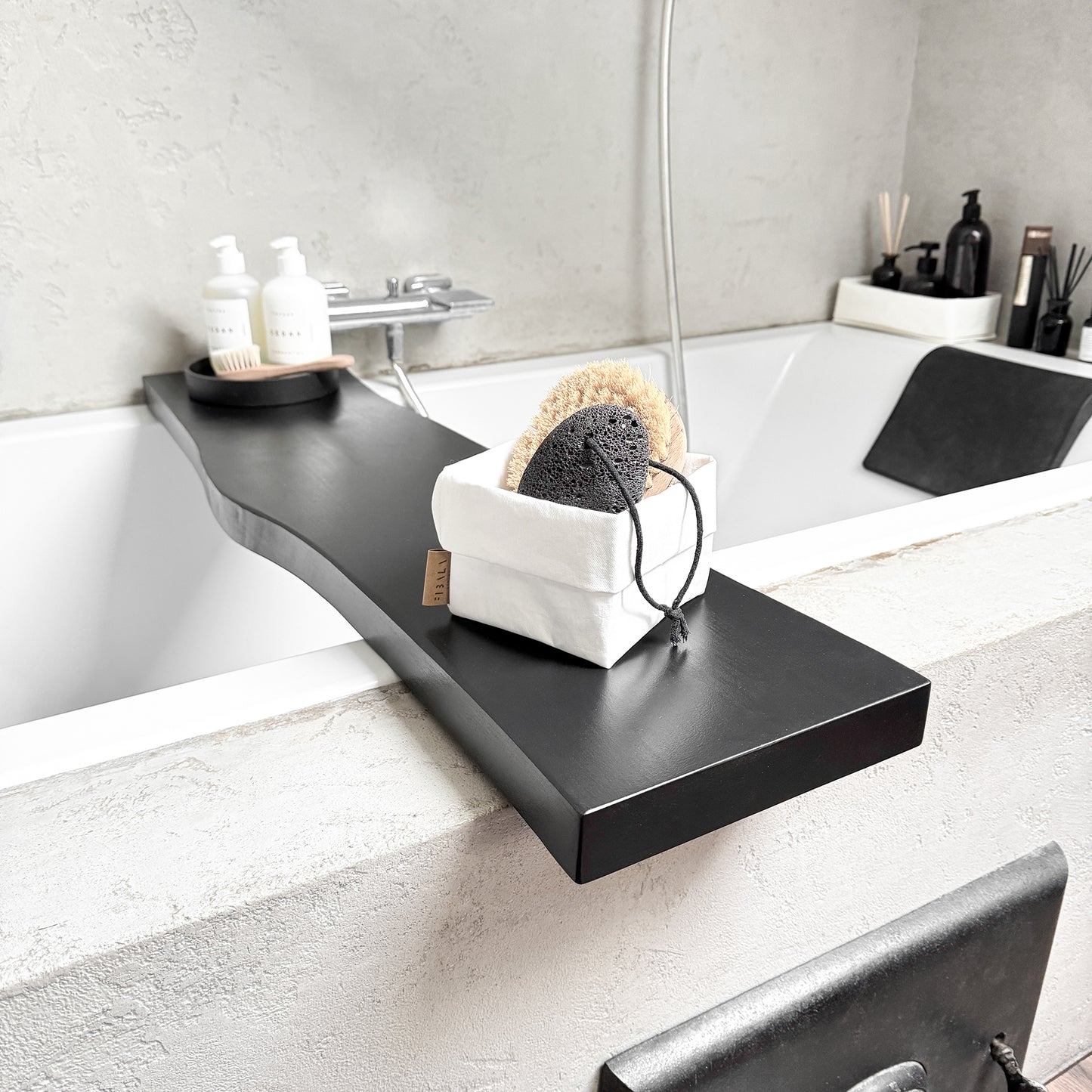 Angle close-up of black live-edge bath caddy, spa tray detail
