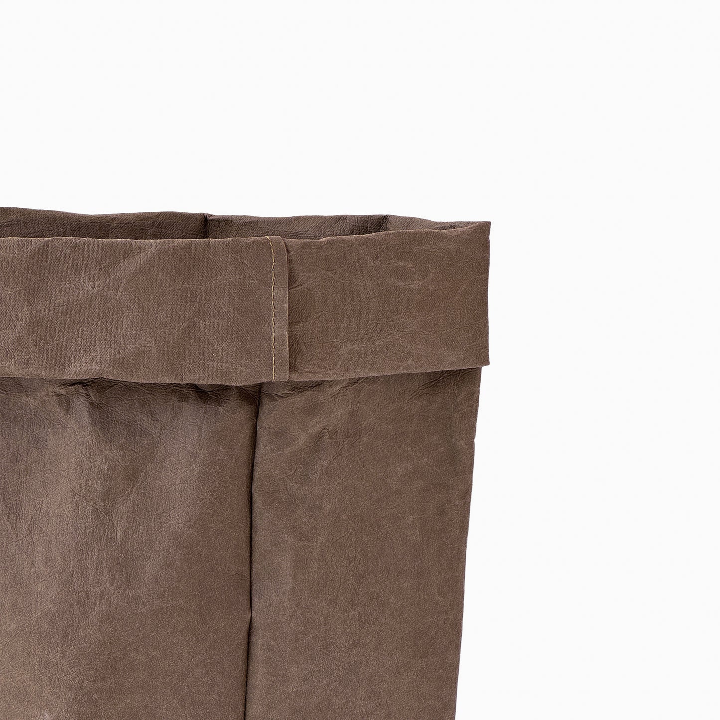 Close-up of a cocoa washable paper bag on a white background