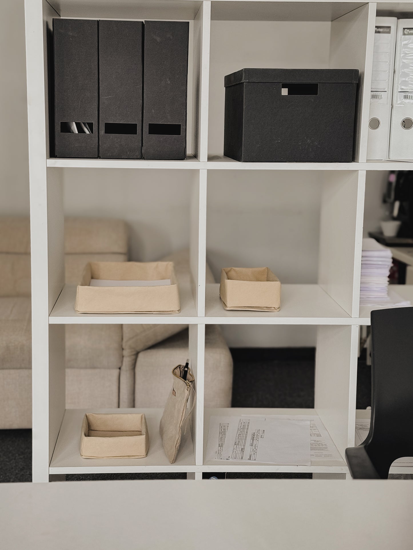 Three sizes of washable paper document tray with dimensions, A4 A5 A6 on a white shelving unit with black folders