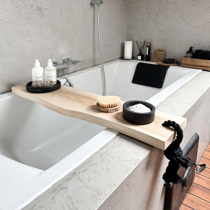 Live-edge ash wood bath caddy, black cotton rope, holds spa essentials on tub rim