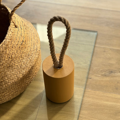 Handmade sun gold concrete door stop close-up texture detail