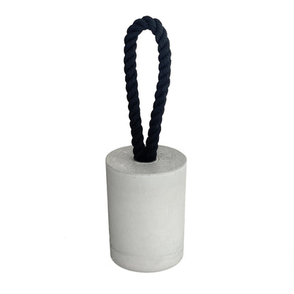 Grey concrete door stop in a clean cylindrical shape with a loop-style black cotton rope handle, displayed against a white background. The image highlights the smooth, textured concrete surface and minimalist design, making it a functional and stylish accent for modern interiors and exteriors.