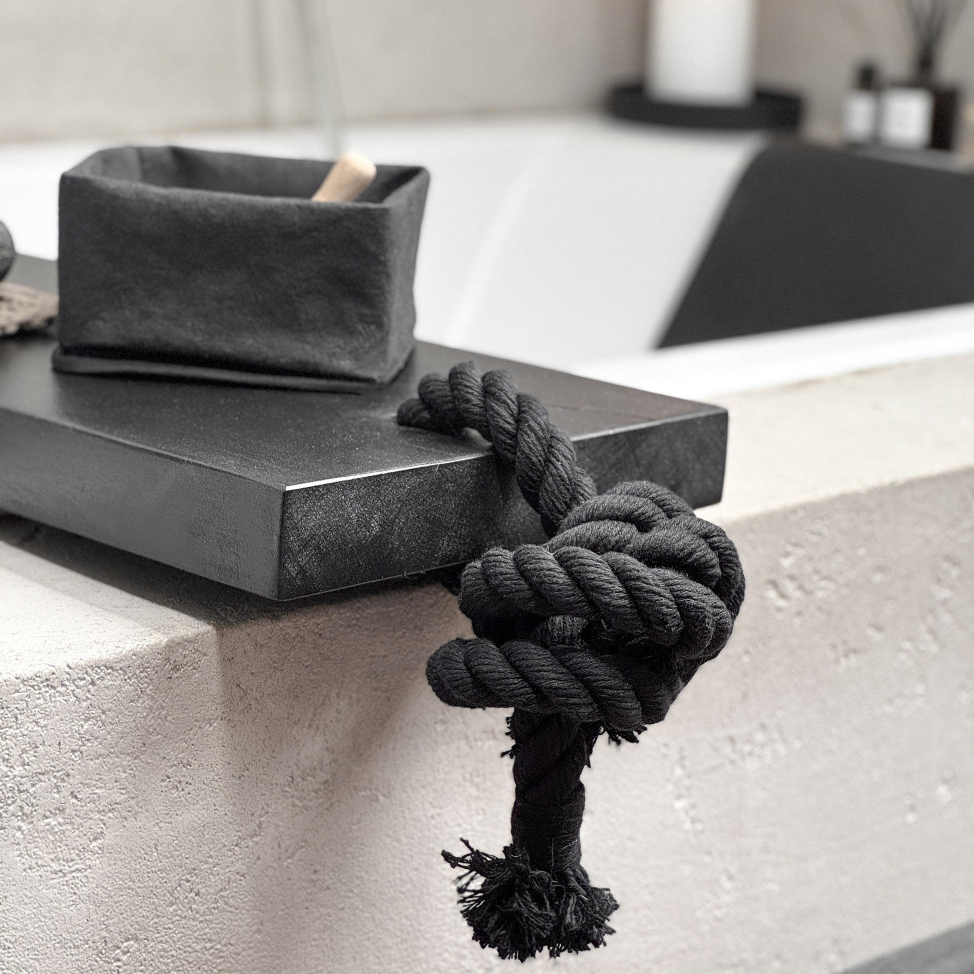Close-up black live-edge bath caddy, black cotton rope, spa-ready tray detail