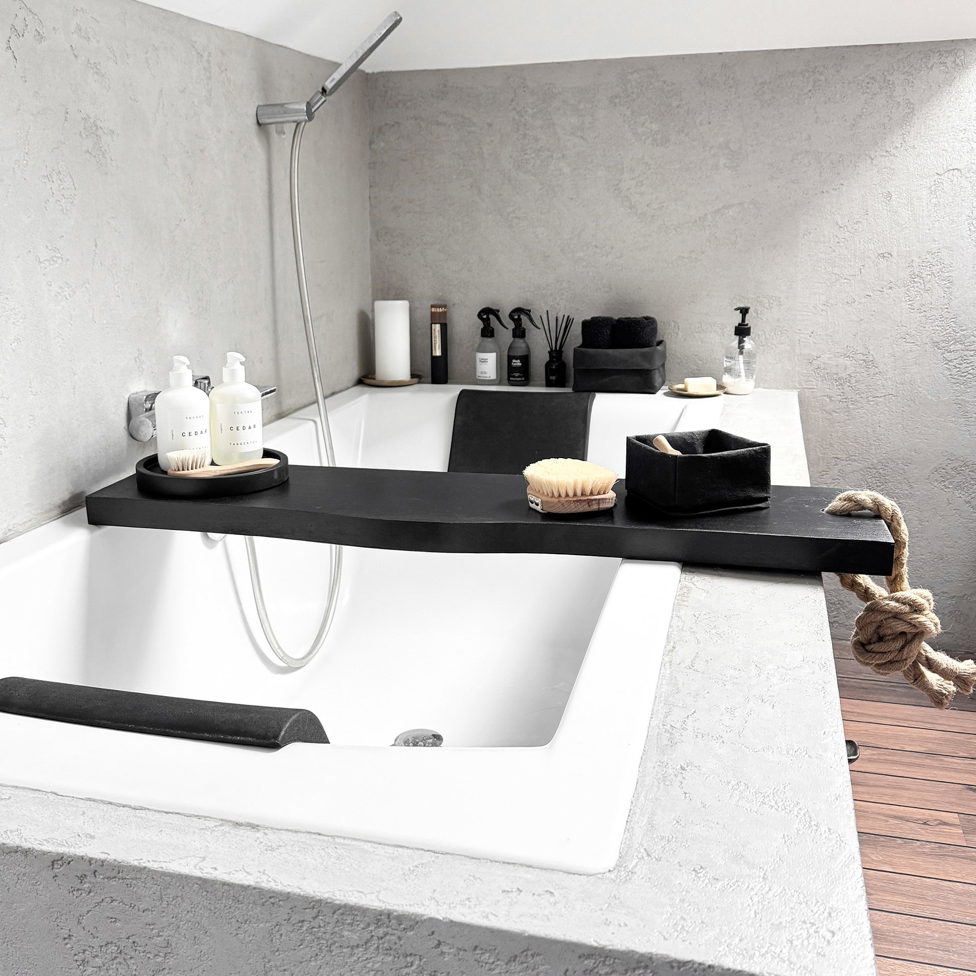 Black live-edge bath caddy, jute rope, front-view spa tray cradling tub-side essentials