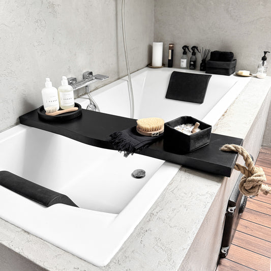 Black live-edge wood bath caddy, jute rope, holds spa essentials on tub rim