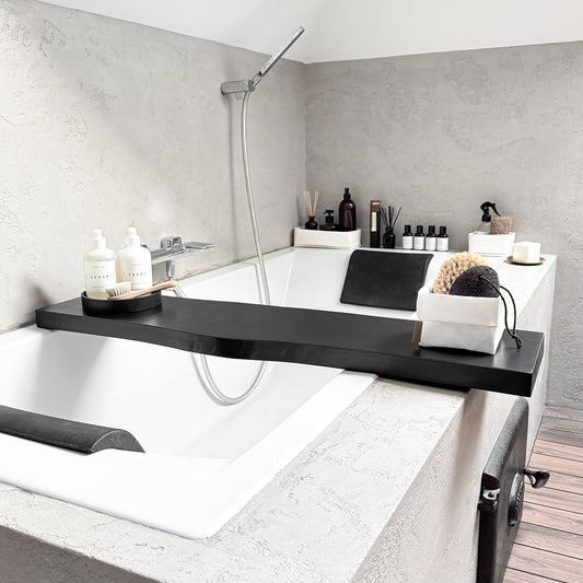 Black live-edge wood bath caddy, holds spa essentials on tub rim