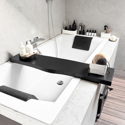 Black live-edge wood bath caddy, holds spa essentials on tub rim