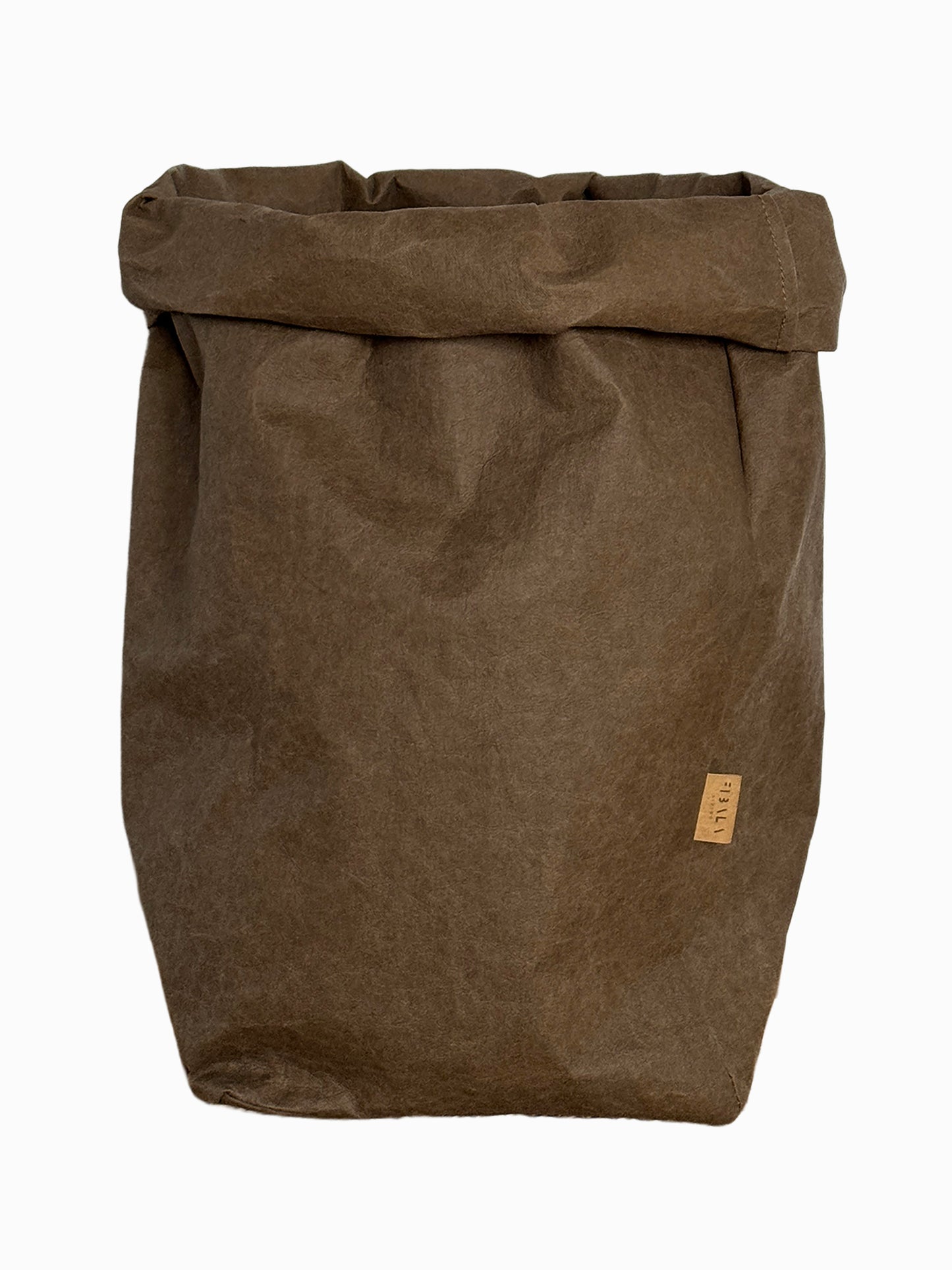 A brown waxed canvas roll-top bag with a small tan leather brand tag on the side, shown against a plain white background.