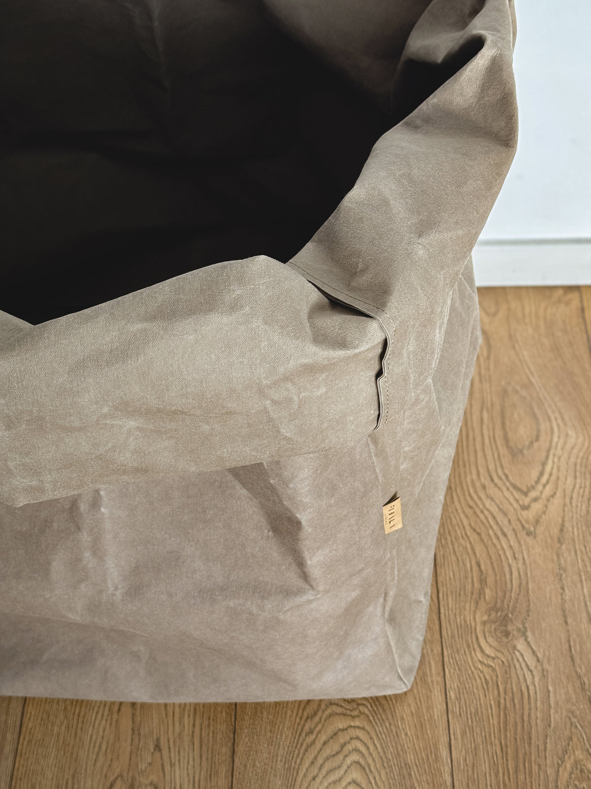 Close-up of textured taupe washable paper fabric, rolled top, Giant Storage Bag detail