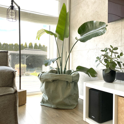 Minimalist giant planter cover made from durable washable paper fitting a large indoor plant pot