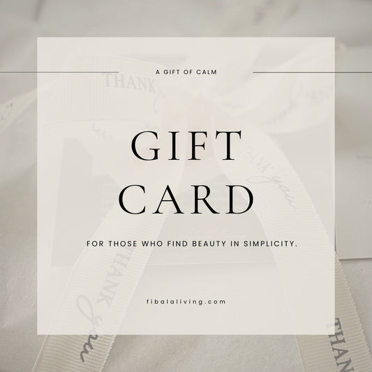 Gift card with text 'A Gift of Calm' and 'Fibataliving.com' on a blurred background.