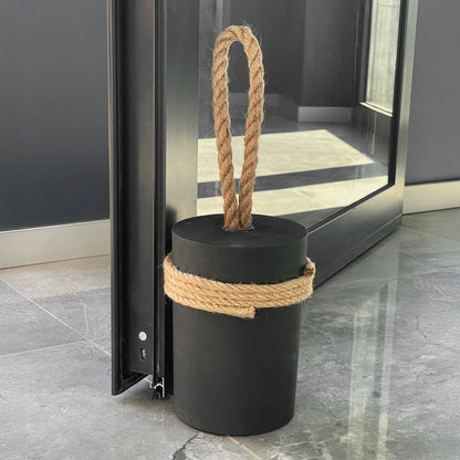 Minimalist 5 kg concrete door stopper with natural jute rope and wrapped base holding heavy office door