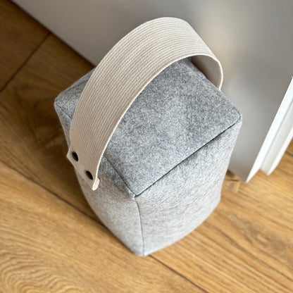Top view of LUND wool door stop with soft wool texture and cotton handle