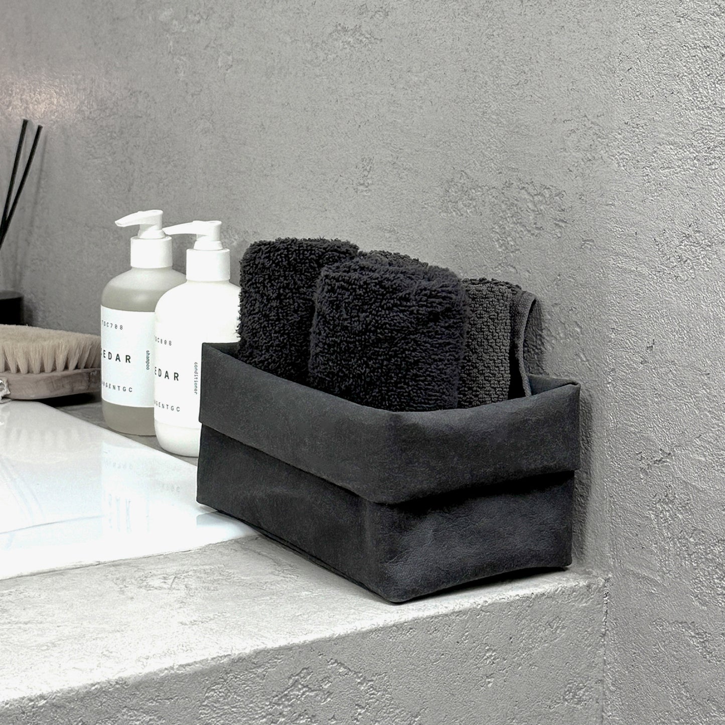 Side-view medium black washable paper box + towels, bath edge—eco storage organizer