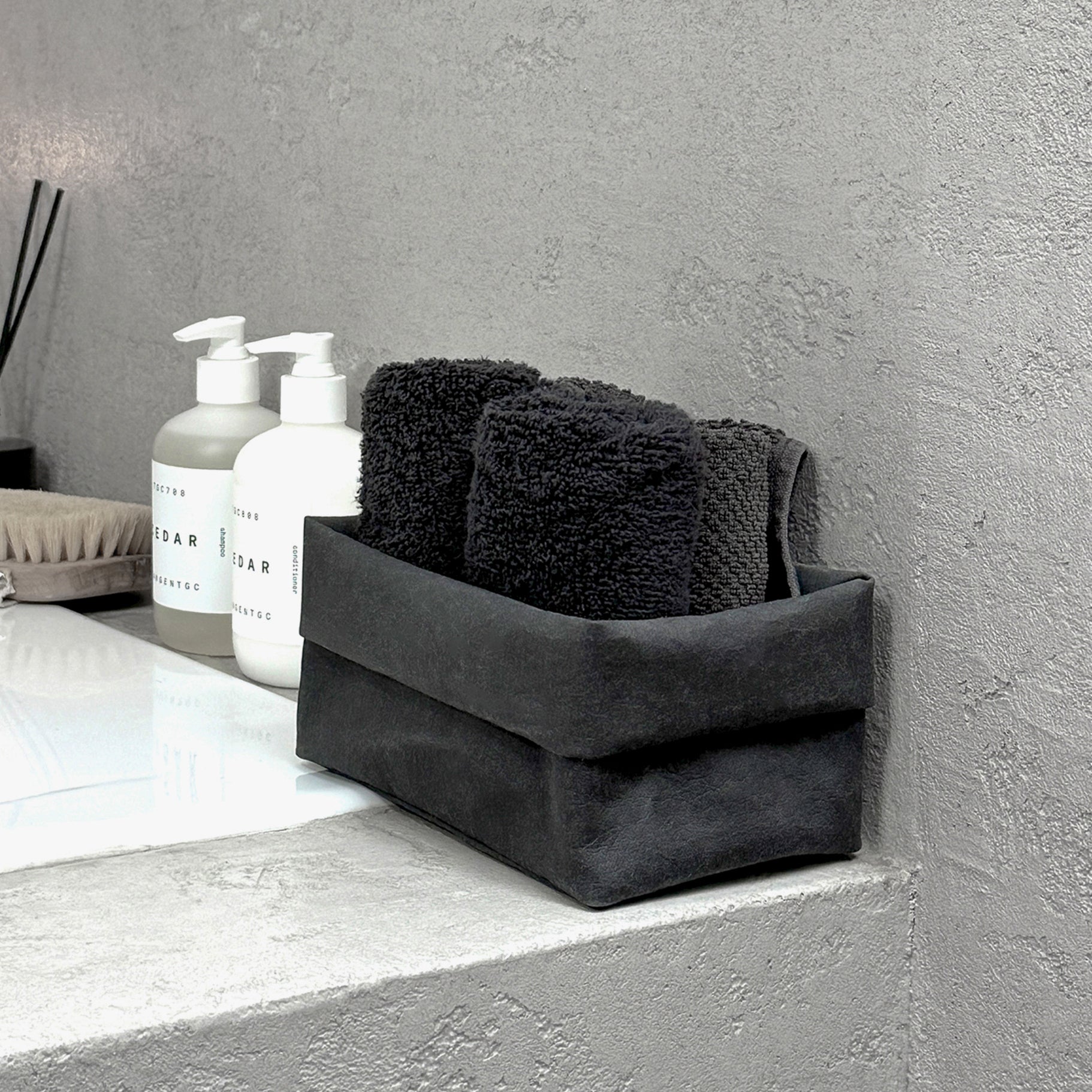 Side-view medium black washable paper box + towels, bath edge—eco storage organizer