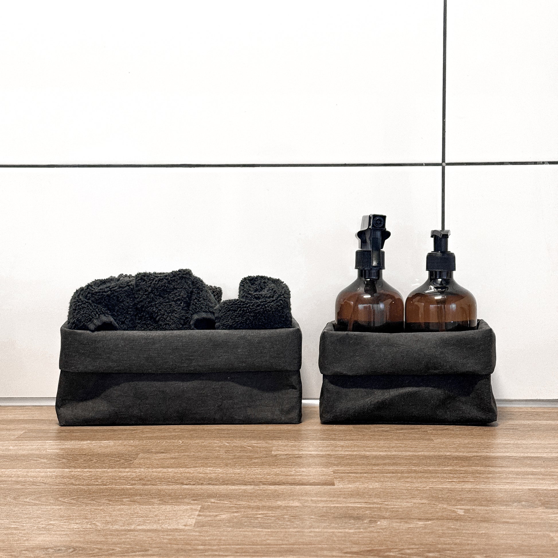 Front-view black washable paper boxes, soap & spray + towels, laundry counter—eco storage set