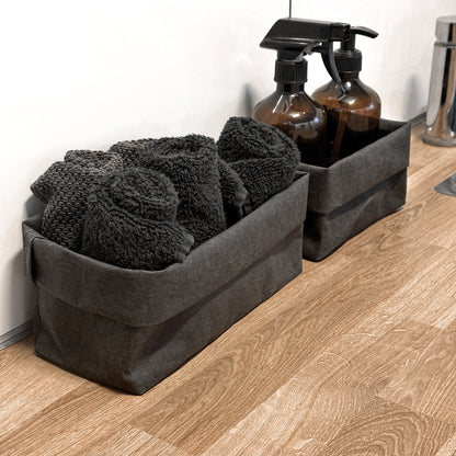 Side-view black washable paper boxes, soap & spray + towels, laundry counter—eco storage set