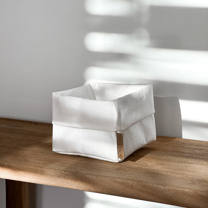 Side-view small white washable paper box, wood table, eco storage