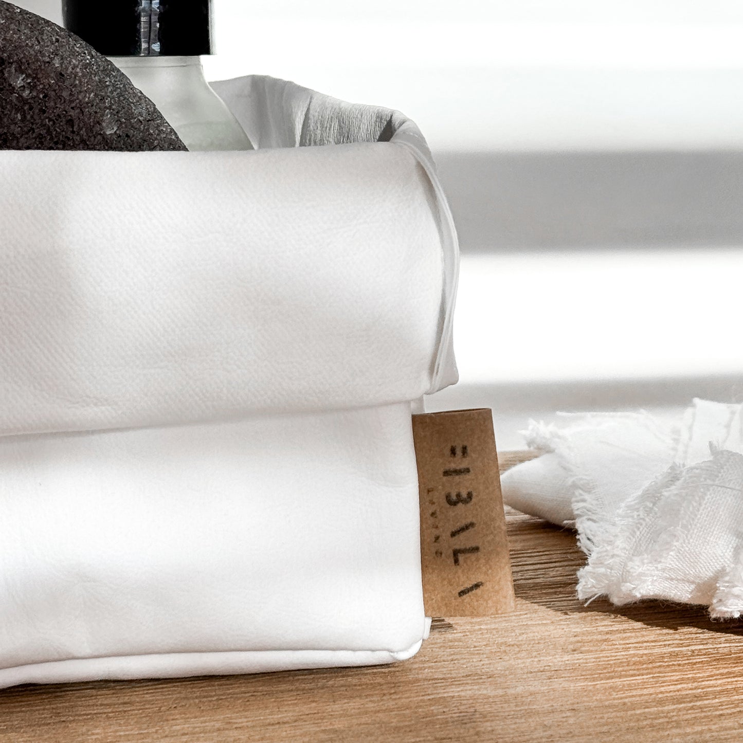 Close-up small white washable paper box, Fibala Living label, toiletries—eco bath storage