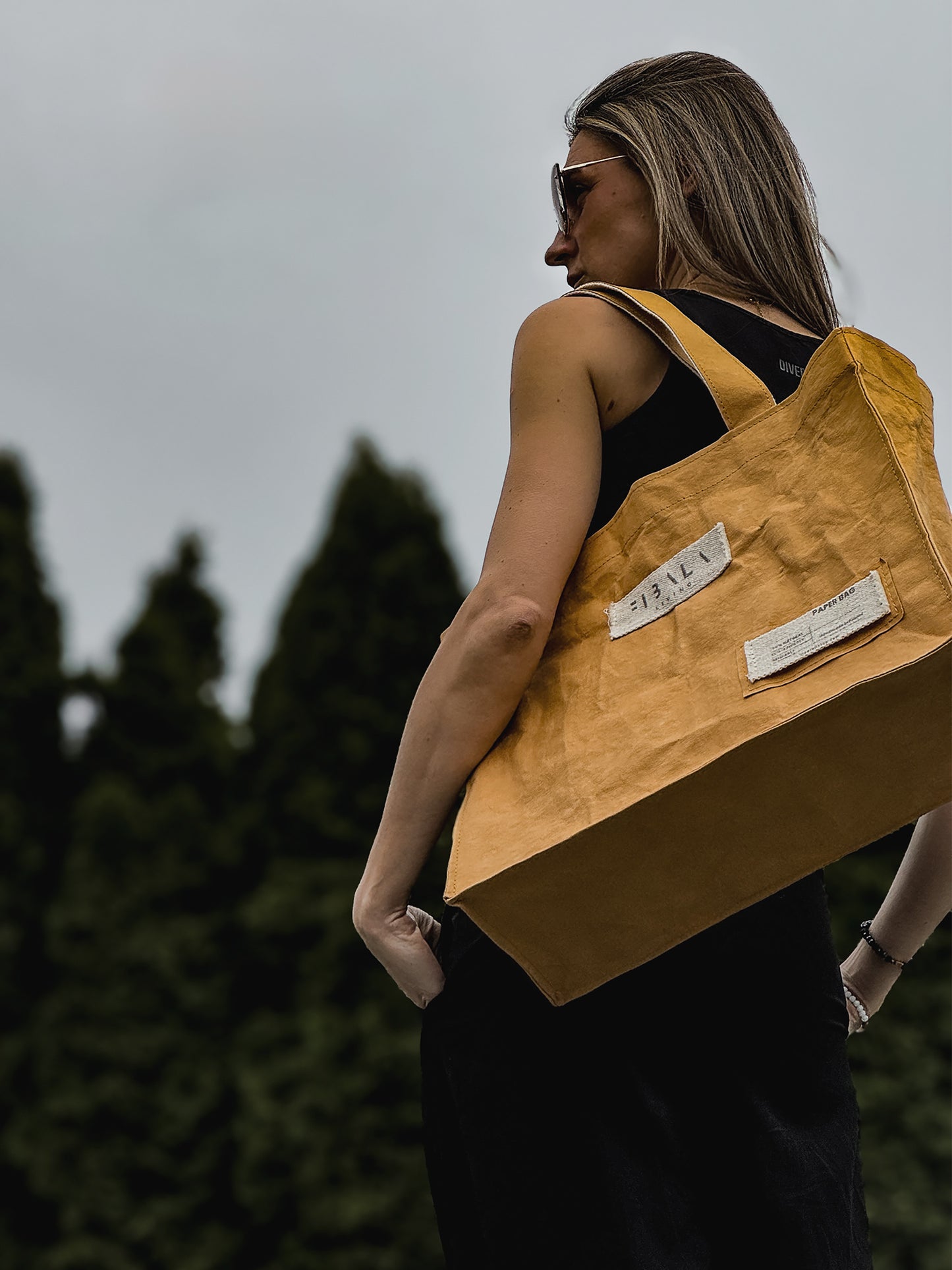 Mustard yellow Fibala carry-all bag worn on shoulder outdoors — structured silhouette, L size