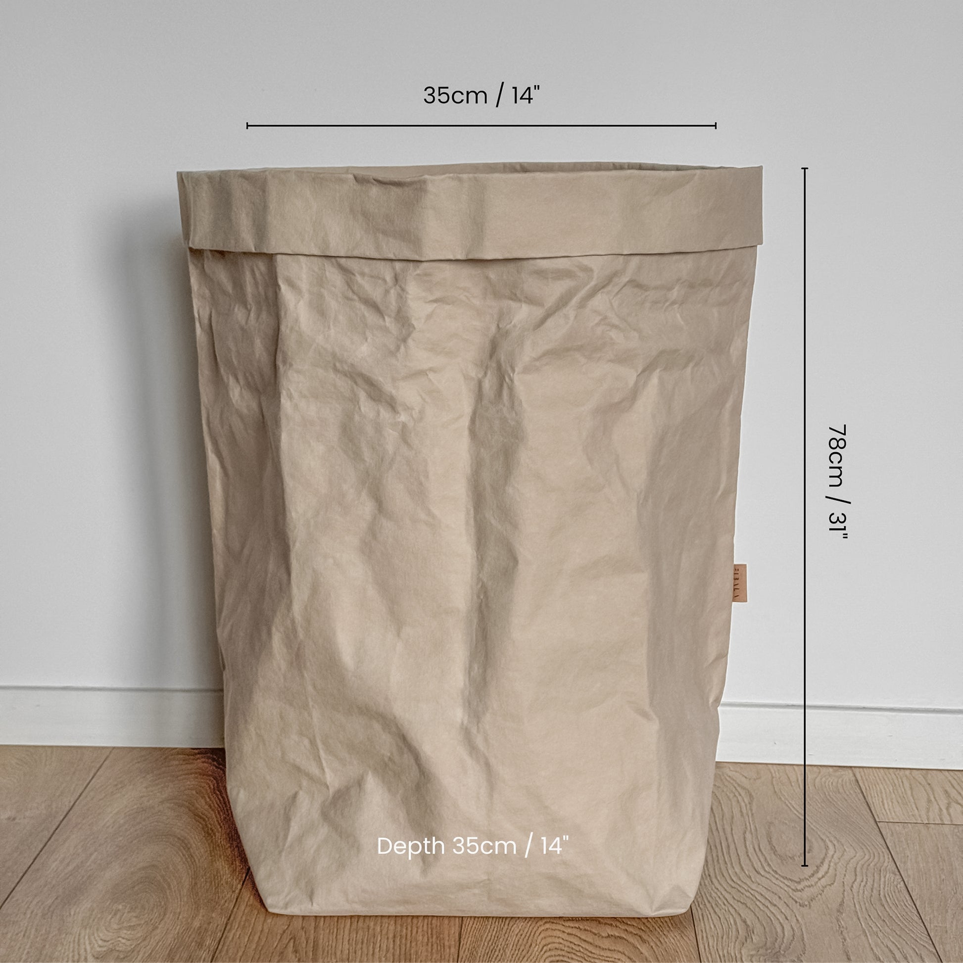 Grande size washable  paper bag with dimensions marked on a wooden floor.