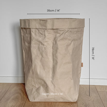 Grande size washable  paper bag with dimensions marked on a wooden floor.
