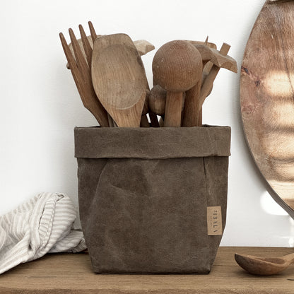 Small Brown Washable Paper Bag Container with Wooden Utensils on Wooden Surface