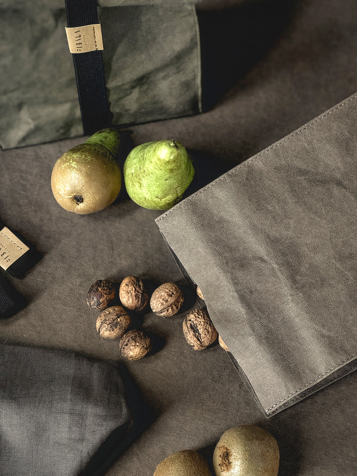 Washable paper lunch bag with pears and walnuts, a second bag with elastic band behind it