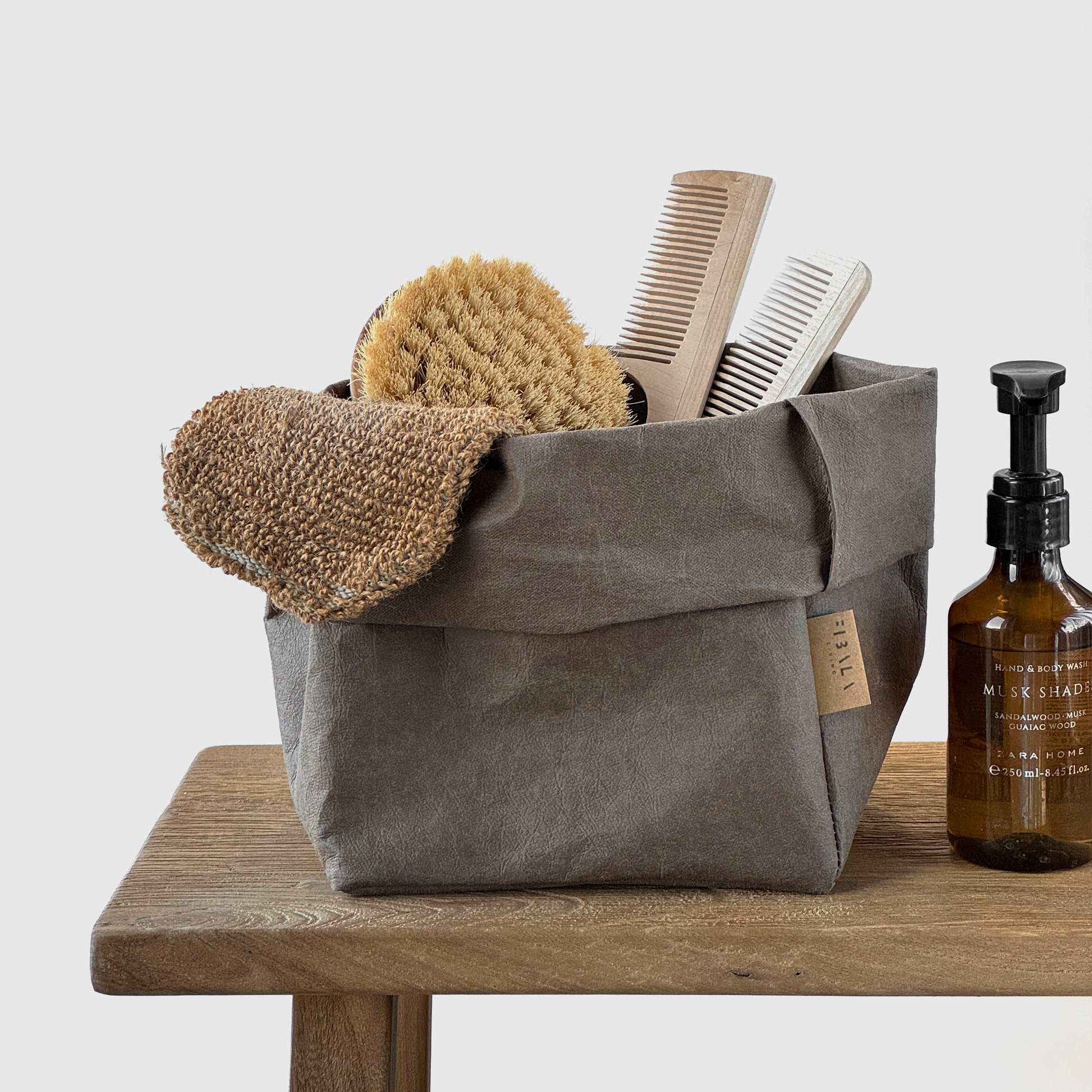 Medium cocoa washable paper bag, toiletries, wood surface—eco reusable tote