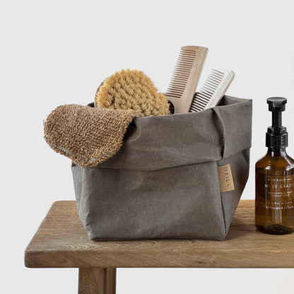 Medium cocoa washable paper bag, toiletries, wood surface—eco reusable tote