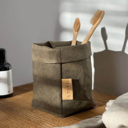Petite olive green washable paper bag, wooden toothbrushes, bottle, wood surface—eco mini tote