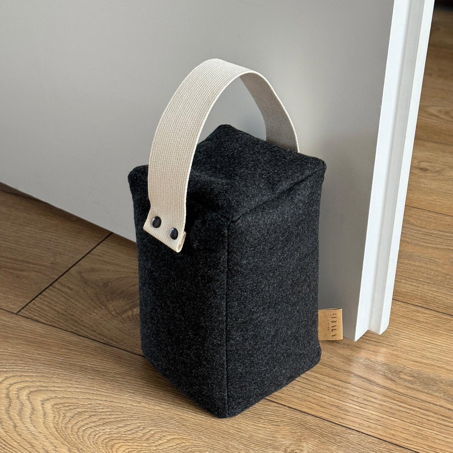 Cozy dark grey wool cube doorstop, natural cotton handle, eco-friendly floor-safe wedge