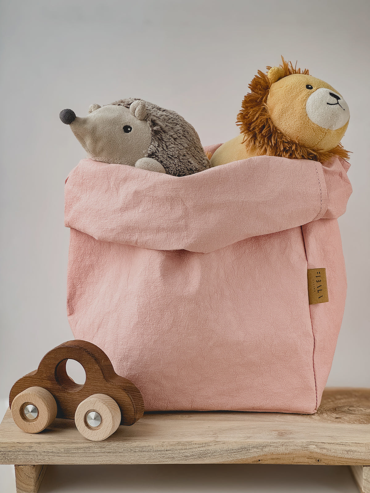 Rose XL washable paper storage bag holding soft toys next to a wooden toy car