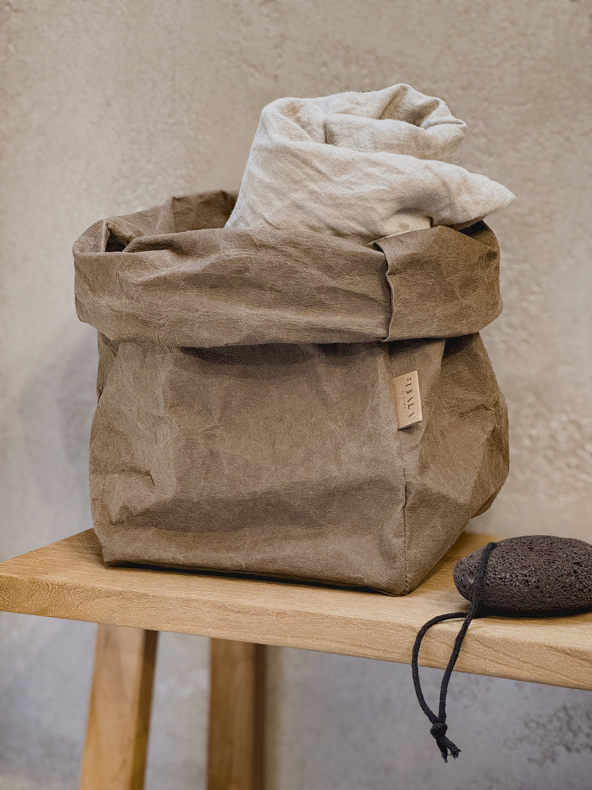 XL washable paper storage bag holding linen on a bathroom bench