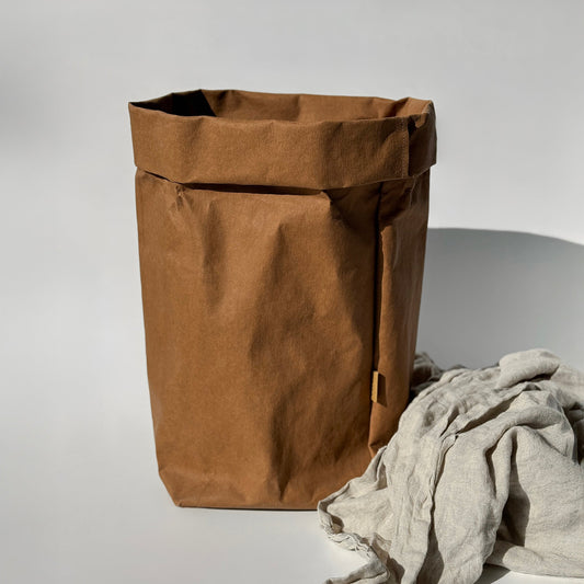XXL brown washable paper bag on light gray background, featuring linen throw fabric inside | Eco-friendly, versatile storage solution