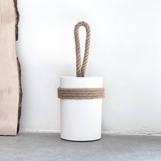 white concrete door stop with natural rope handle and jute string detail, placed indoors next to wooden board on concrete floor — perfect for coastal or modern farmhouse decor